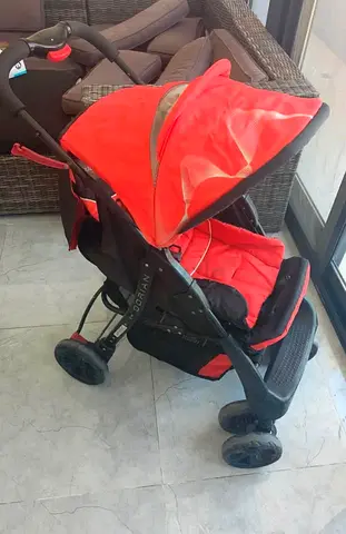 Red lightweight baby stroller / pram in good condition