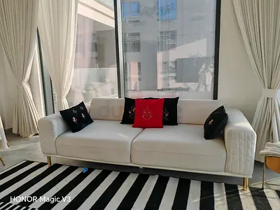 Modern white 3-seater sofa with gold legs