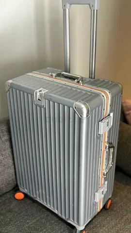 Silver hard-shell trolley suitcase with orange wheels — good condition