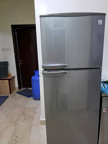 Silver double-door refrigerator in good working condition - Daewoo