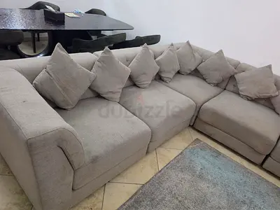 Light grey L-shaped fabric corner sofa with cushions - good condition