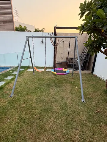 Metal frame garden swing set with two round disc swings - good condition