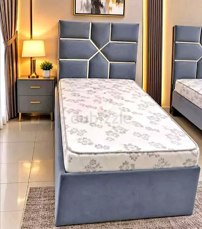 Single upholstered bed frame with geometric padded headboard - grey