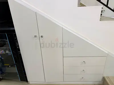 Custom built-in under-stairs white cupboard with drawers (fits sloped ceiling)