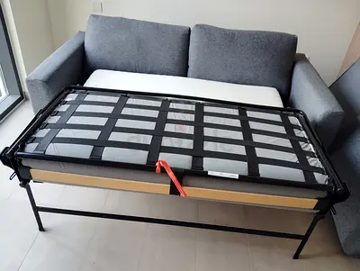 Grey 2-seater sofa bed with pull-out metal frame, good condition