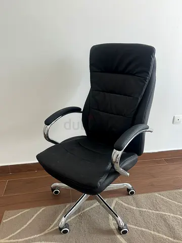 Black leather swivel office chair with armrests and casters - good condition