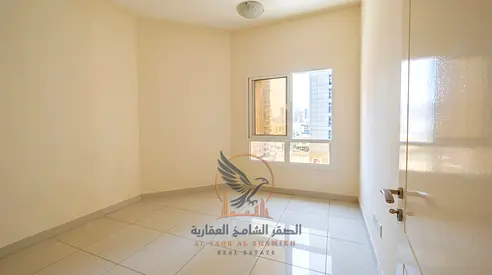 For annual rent in Ajman: Two bedrooms, living room, balcony, and open view in Al Nuaimiya 1. Features include two bathrooms, built-in wardrobes