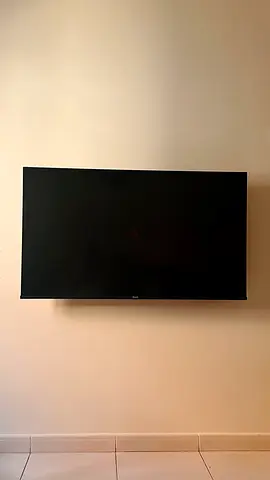 Slim 55-inch LED wall-mounted TV in good condition