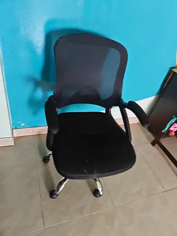 Black ergonomic mesh office chair with armrests