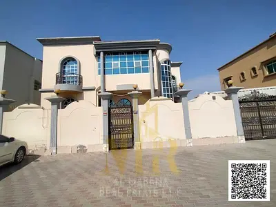 Villa for sale in the Al Rawda area, Ajman. It features 5 master bedrooms, a majlis, 2 living areas