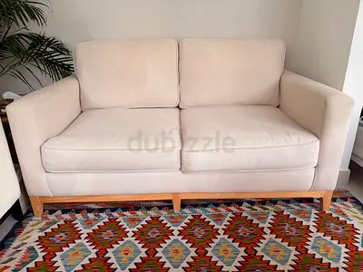 Beige 2-Seater Sofa with Wooden Base — Good Condition