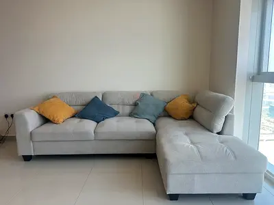 Light grey L-shaped fabric sofa, in excellent condition