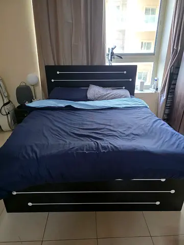 Queen size black wooden bed frame with headboard and storage