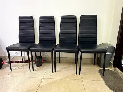 Set of 4 black dining chairs with faux leather upholstery