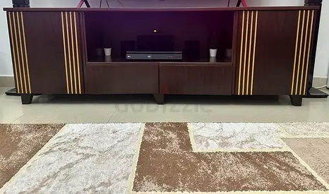 Dark wood entertainment TV cabinet with gold stripe accents - good condition