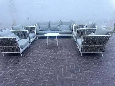 Outdoor patio lounge set with sofa, armchairs and coffee table