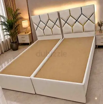 Pair of modern upholstered single beds with storage-ready bases