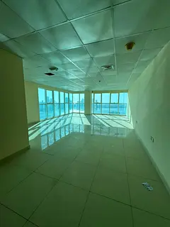 office for annual rent in Al Majaz 2 | Free AC | parking | Sea view overlooking Al Majaz Lake | Suit