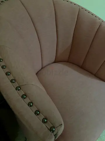 Single upholstered accent armchair in blush beige with studded trim
