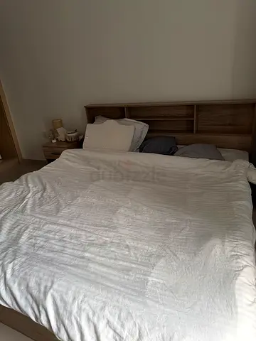 king sized bed with mattress, one nightstand, one shoe cabinet and dresser with chair