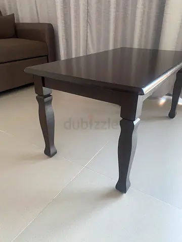 Solid wood dark brown coffee table with carved legs