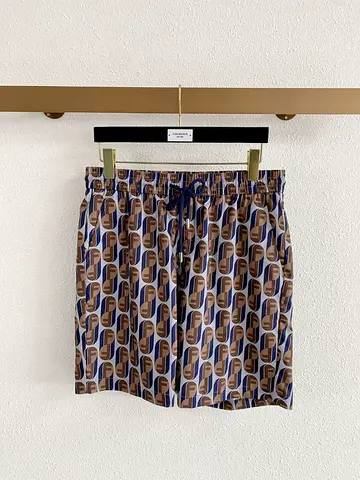 Men's patterned swim shorts, size likely M — navy/brown geometric print