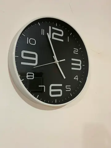 Black wall clock with white frame - working condition