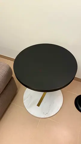 Round black-top side table with heavy duty marble base - good condition