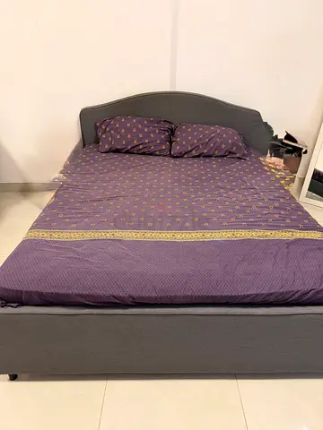 Grey upholstered double bed with headboard — good condition