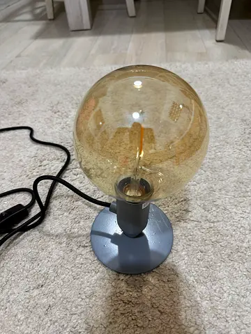 Small modern bedside table lamp with amber glass globe