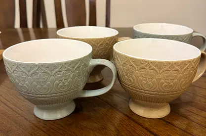 Set of 4 embossed ceramic cups.