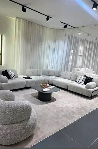 Light grey modular curved sofa set with matching boucle armchair