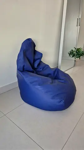 Furnished large blue bean bag chair — comfortable casual seating