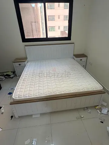 White wooden double bed with mattress and matching bedside tables, King Size