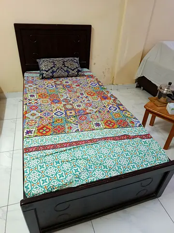 Single wooden bed with mattress and patterned bedsheet - good condition