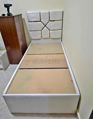Single white upholstered bed with padded headboard - good condition