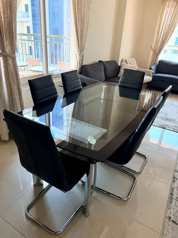 Glass Top Dining Table with 6 Black Leather Chairs - Good Condition