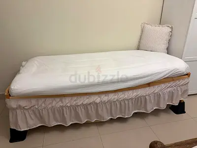 2 single wooden bed frames with mattresses