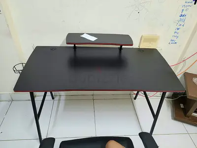Compact black gaming/study desk with monitor riser