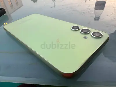 Green triple-camera smartphone in good condition - minimal signs of use
