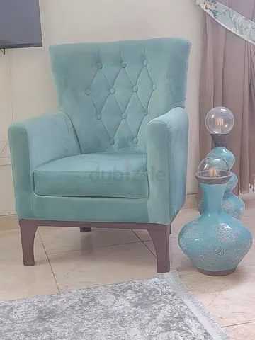 The One Store Light teal upholstered accent armchair with tufted back and solid legs used very littl