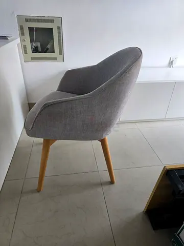 Grey upholstered dining/occasional chair with wooden legs
