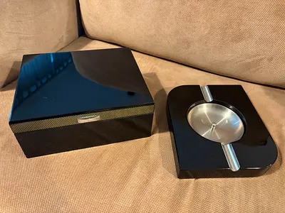 Glossy black cigar humidor box with matching ashtray