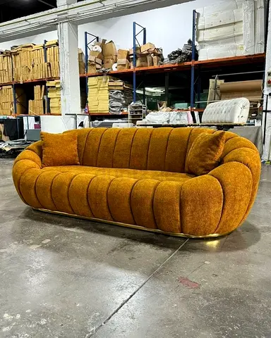 Vintage mustard curved 3-seater sofa with brass base