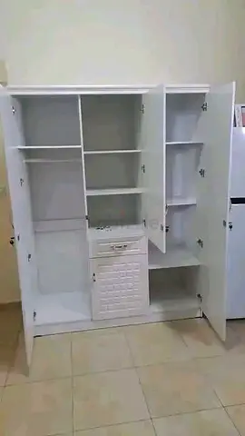 White wooden wardrobe / cupboard with multiple shelves and drawers
