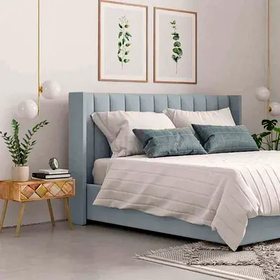 Light blue upholstered queen bed with tufted headboard