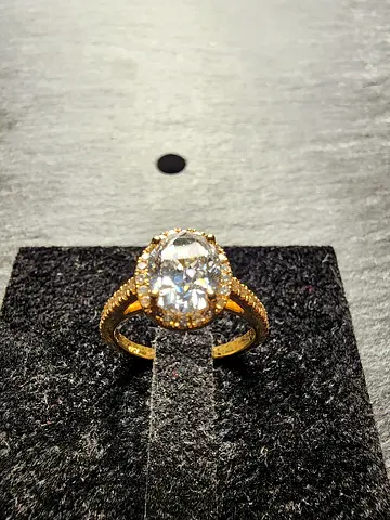 Gold ring with large central clear  oval colorless natural diamond in a pave setting GIA certified