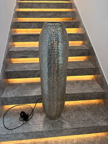 Tall decorative floor lamp with textured metallic finish