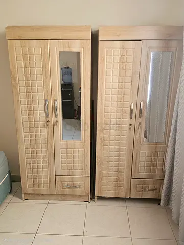 Two matching light-wood wardrobes with mirrors, good condition.. (One for AED 200, TAKE BOTH FOR 350