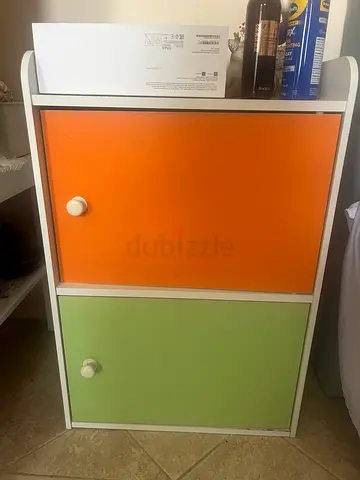 Small two-drawer bedside cabinet in white with orange and green fronts
